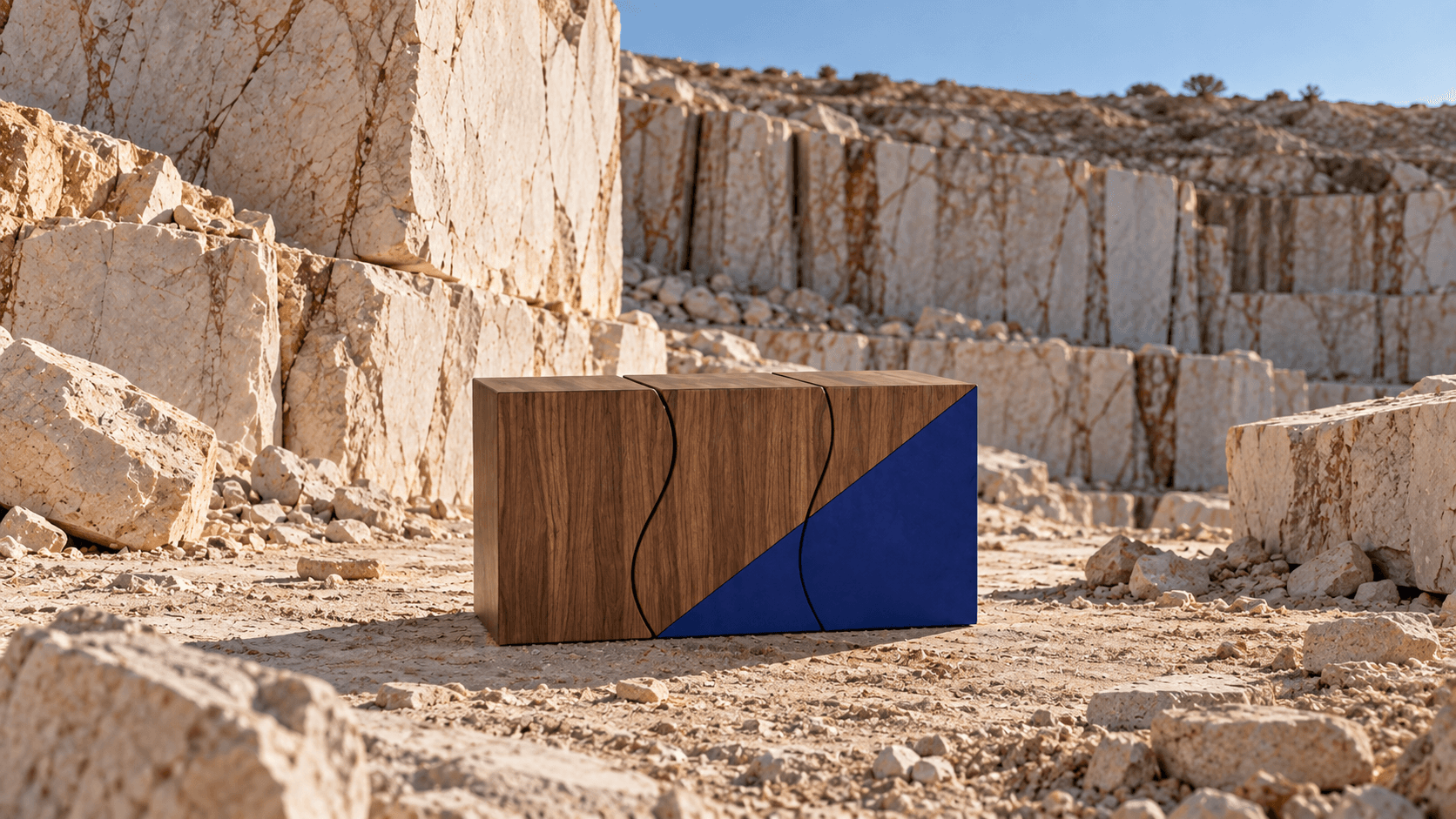 Sculptural stools in a stone quarry, walnut above and blue below joined by a wave-like line