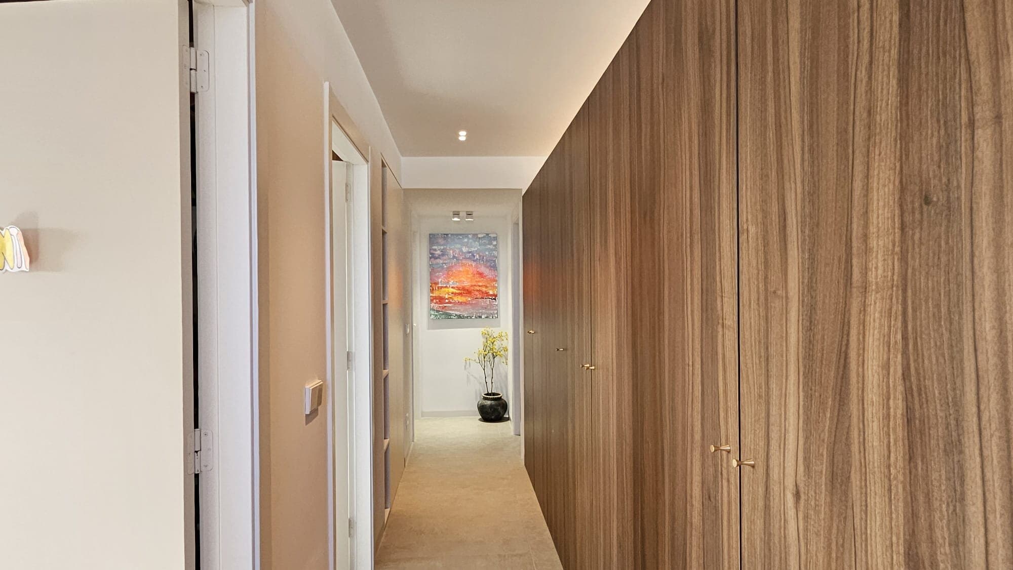 Atardeceres painting at the end of a contemporary hallway